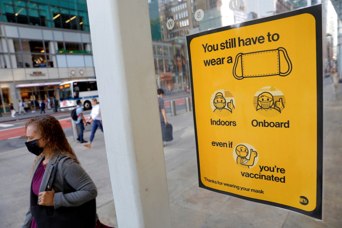 A poster alerting for the wearing of masks is seen on a 42nd Street subway entrance in New York City, on Aug. 2, 2021. (Andrew Kelly/Reuters)
