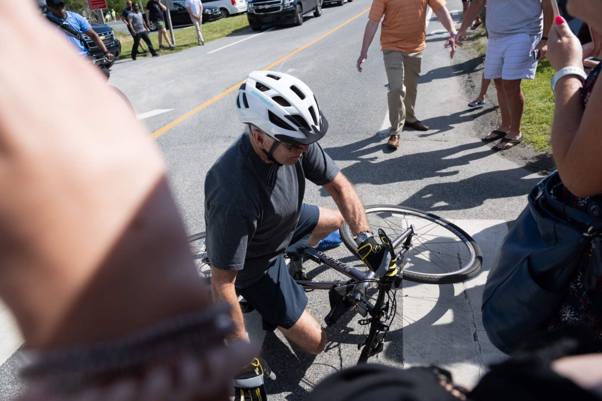 President Joe Biden falls off his bicycle following a bike ride in Rehoboth Beach, Del., on June 18, 2022. (Saul Loeb/AFP/Getty Images)